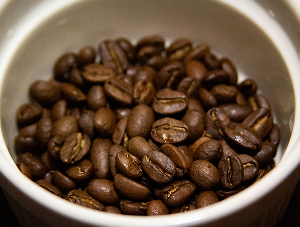 Weighing whole coffee beans for pourover coffee