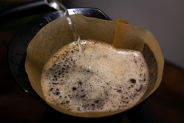 Pouring water on coffee with a gooseneck kettle